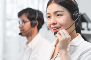 Close-up of a smiling customer service real estate agent wearing a headset.