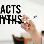 Hand crossing out 'Myths' and replacing it with 'Facts'