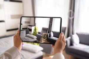 Real estate agent working on a desktop displaying a house image.