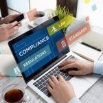 Person using laptop with floating icons for compliance, law, and regulations.