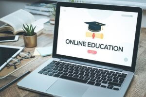 Laptop displaying "Online Education" with a graduation cap graphic.
