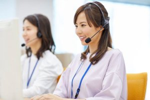 Call center agents with headsets smiling at work