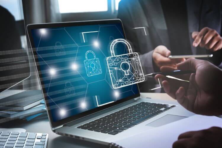 Business professionals collaborating on a laptop, featuring a security icon, representing freelancers in the Philippines.