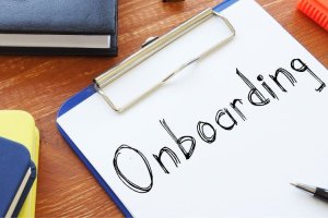 Clipboard with onboarding text written on paper