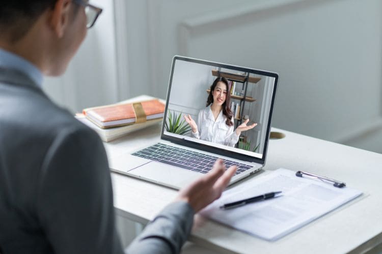 Businessman in video call with colleague on laptop