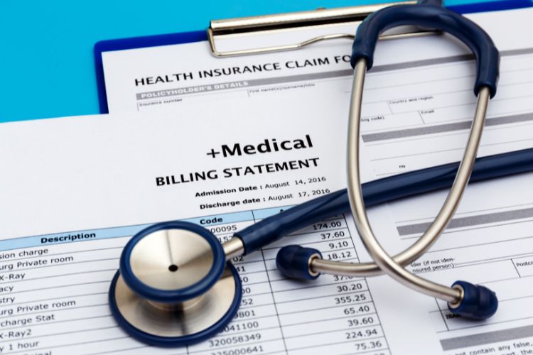 A medical billing statement next to a stethoscope, representing the intersection of healthcare billing and medical practice.