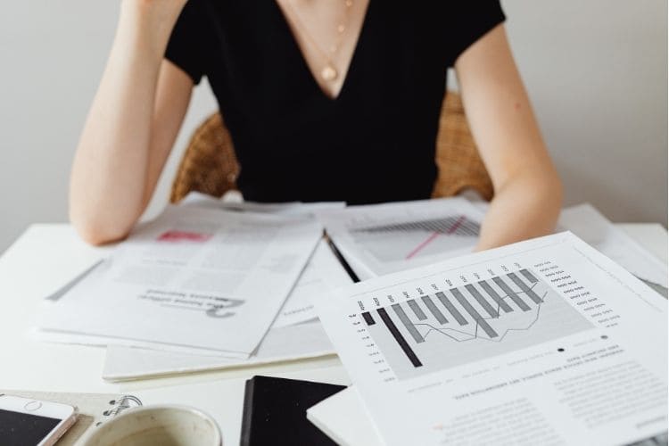 Stressed accountant at a desk representing how outsourcing provides support during busy tax seasons.