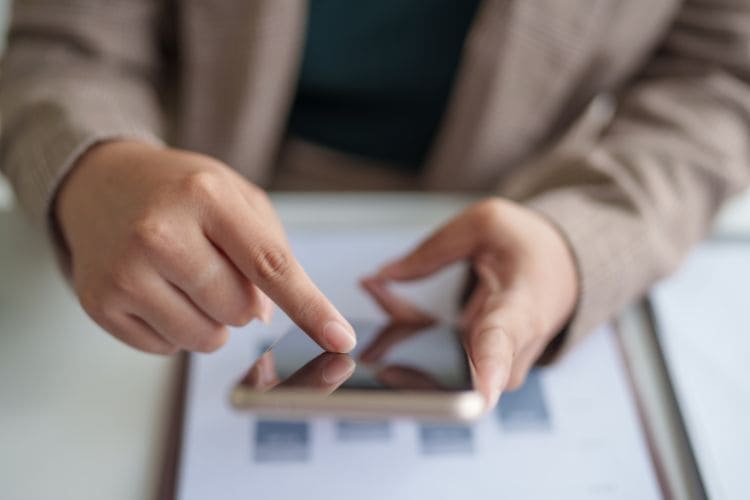 Person managing tasks on smartphone device