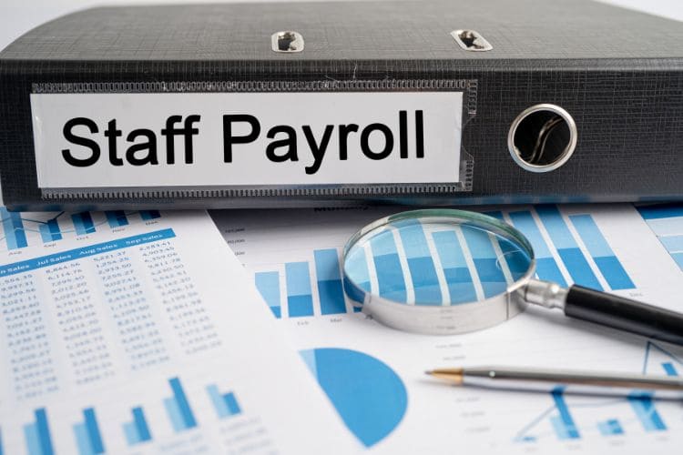 Staff payroll binder with financial reports and charts