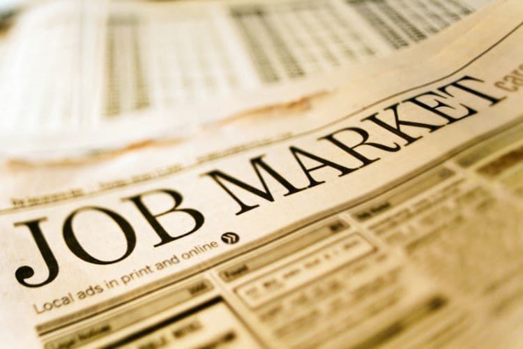 Newspaper job market section with classified employment listings