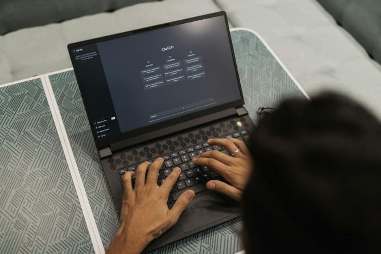 CreaThink Solutions | How to Scale Your Team with Remote Staff (Without Disrupting Operations) Remote worker using AI chatbot platform on laptop for productivity and automation