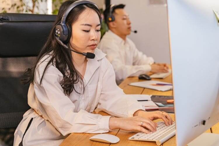 Remote customer service agents wearing headsets while handling client support tasks