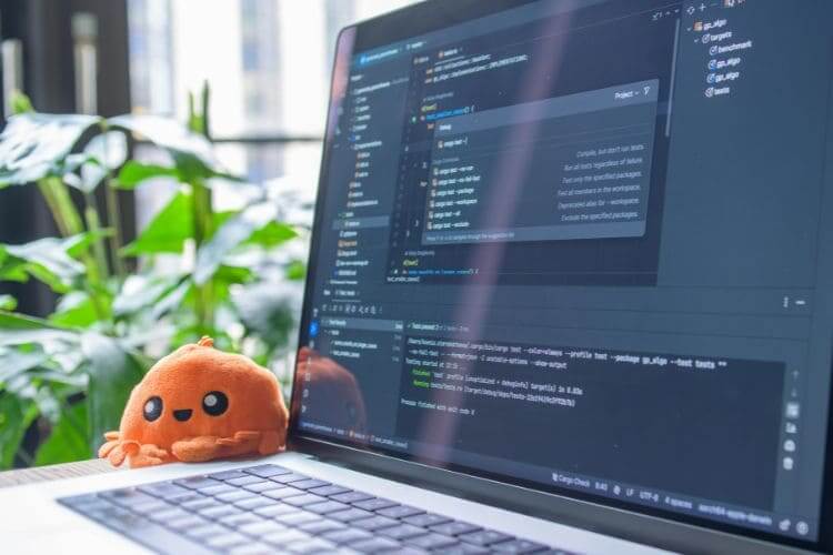 Software development workstation displaying programming code on laptop screen