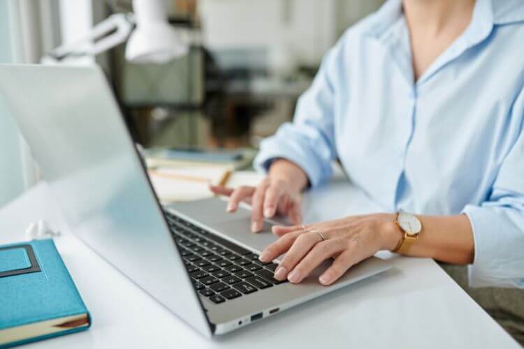 Virtual assistant working on a laptop in a modern home office, providing remote administrative support.