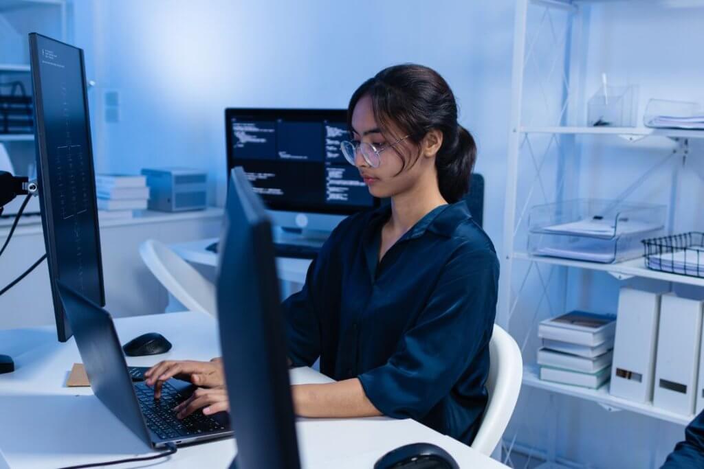 Remote AI software developer working on coding and application development in a modern workspace.