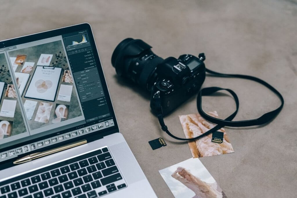 Laptop and camera arranged for digital photo editing.