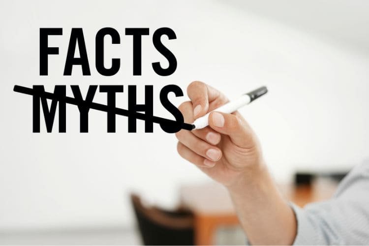 Hand crossing out 'Myths' and replacing it with 'Facts'