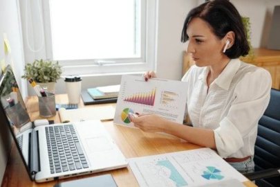 Woman presenting financial charts during an online video call.