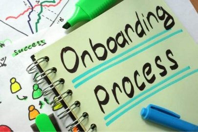 Notebook with the words "Onboarding Process" highlighted in blue.