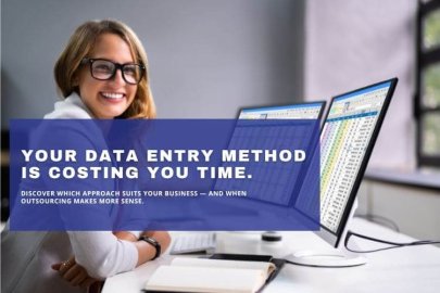Professional data entry specialist working with spreadsheets and dual monitors in office