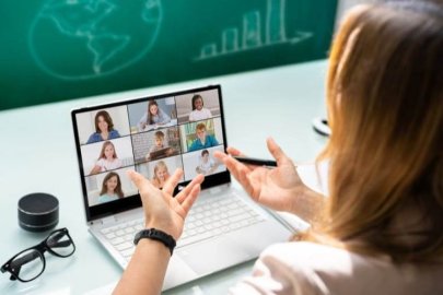 Woman attending a video conference with multiple participants.